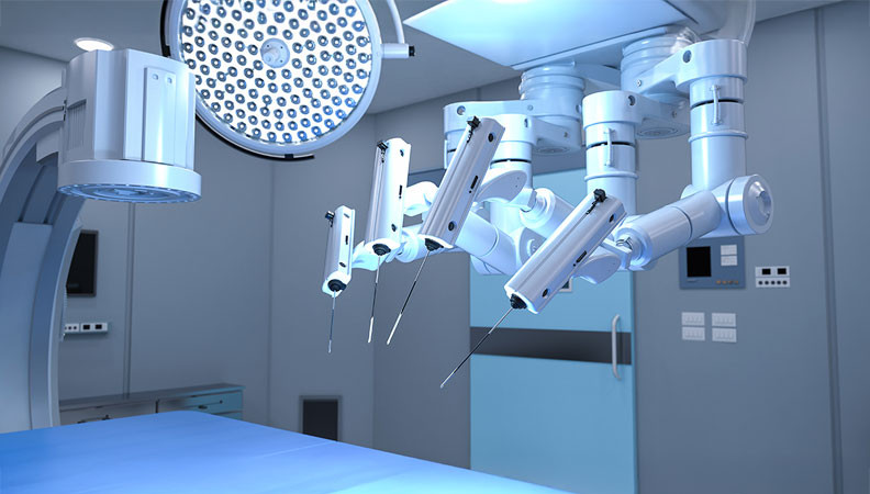 A high-tech surgical room featuring robotic surgical arms equipped with instruments, illuminated by overhead surgical lights. The walls are smooth and the environment appears sterile and modern.