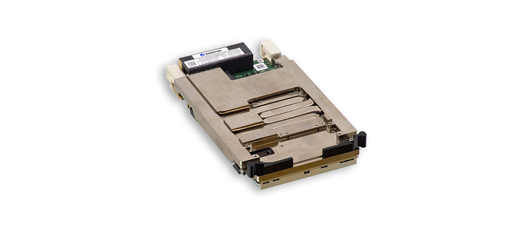 A metallic electronic component with a rectangular shape, featuring multiple grooves and connectors. The surface is smooth and reflective, with labels and a circuit board visible on one side.