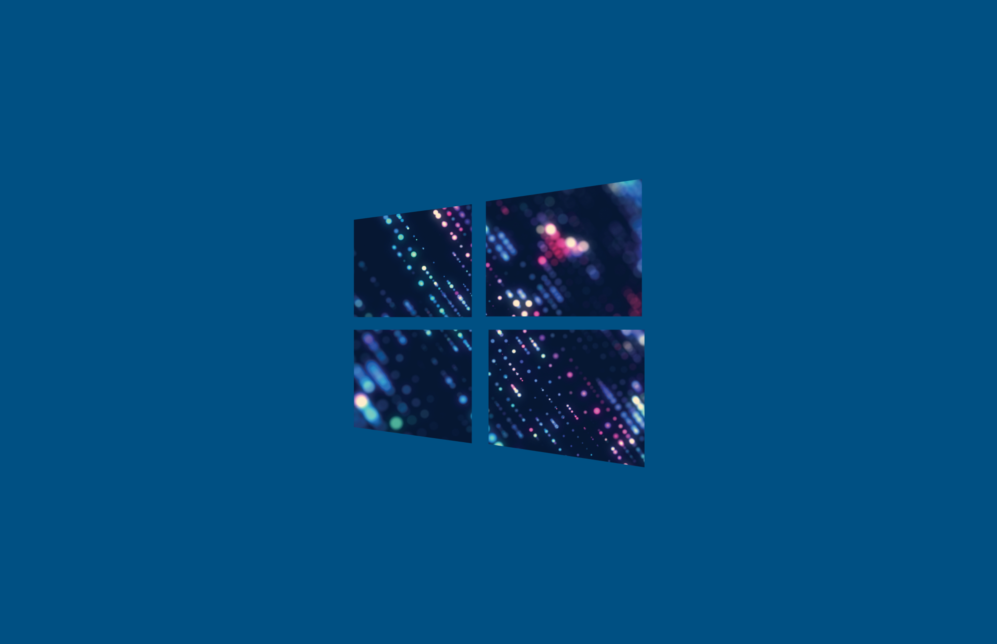 A stylized representation of the Windows logo, composed of four squares, set against a blue background. The squares feature a colorful abstract design with dots and light effects.